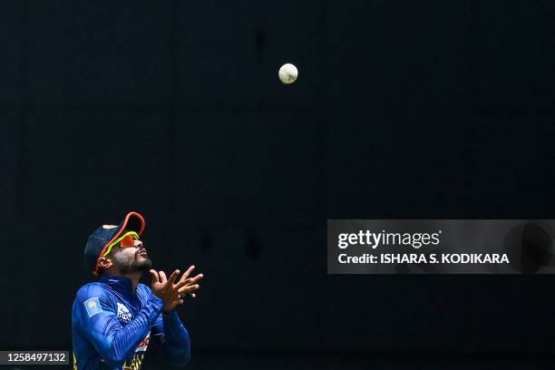 Sri Lanka's Dhananjaya de Silva catches the ball to dismiss Afghanistan's Gulbadin Naib during the third and final one-day international cricket...