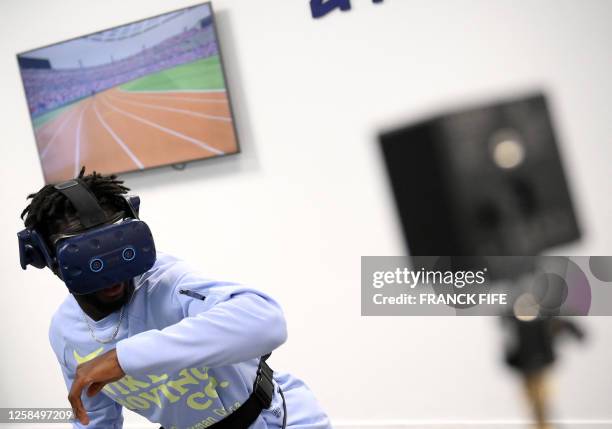 French athlete and member of the French 4x100 m relay team, Ryan Zeze, trains with a virtual reality headset in Paris, on June 1, 2023. "Leave...