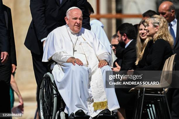 Pope Francis, seated in a wheelchair, prepares to leave at the end of the weekly general audience on June 7, 2023 at St. Peter's square as in The...