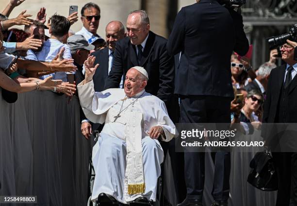 Pope Francis waves to attendees as he leaves at the end of the weekly general audience on June 7, 2023 at St. Peter's square as in The Vatican. Pope...
