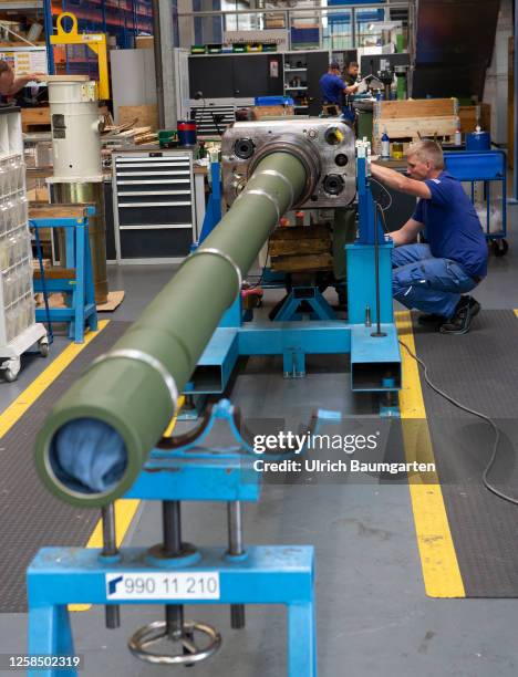 Technicians from the armaments group Rheinmetall AG work on gun barrels for the Leopard 2A4 battle tank in one of the group's production hall on June...