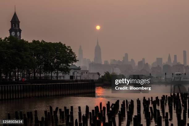 Buildings in the Manhattan skyline shrouded in smoke from Canada wildfires at sunrise in Jersey City, New Jersey, US, on Wednesday, June 7, 2023. New...