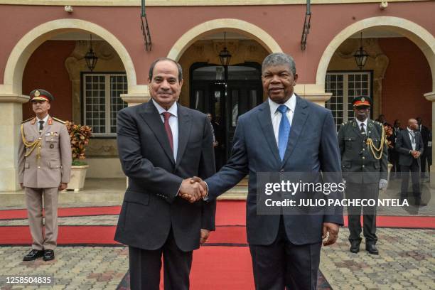 Angola President Joao Lourenco and Egyptian President Abdel Fattah al-Sisi shake hands in Luanda on June 7, 2023 at the start of their meeting.