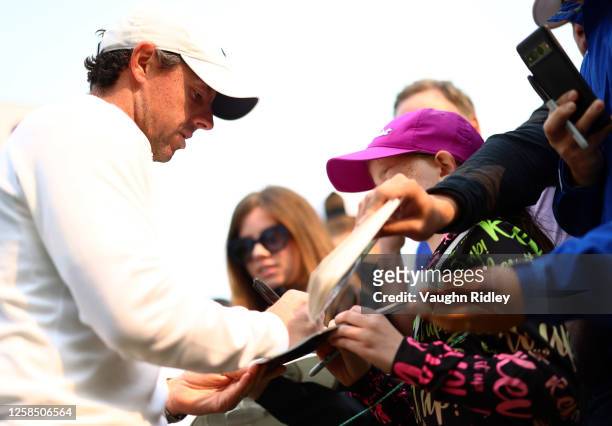 Rory McIlroy of Northern Ireland signs autographs for fans following the Pro-Am of the RBC Canadian Open at Oakdale Golf and Country Club on June 07,...
