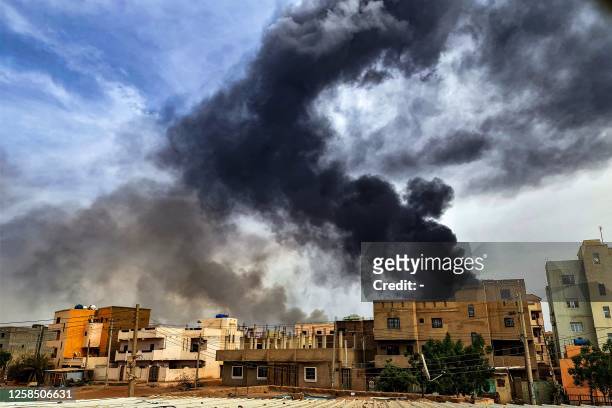 Smoke plumes billow from a fire at a lumber warehouse in southern Khartoum amidst ongoing fighting on June 7, 2023. Eight weeks of fighting have...