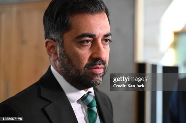 First Minister Humza Yousaf faces the media in the lobby of the Scottish Parliament after Circular Economy Minister Lorna Slater announced the...