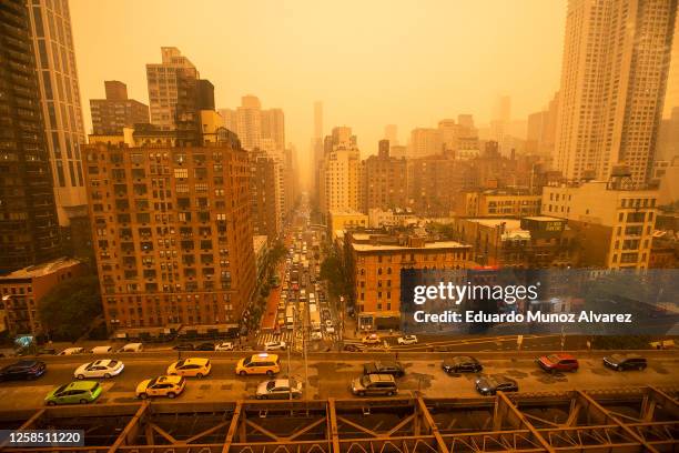 Traffic moves over the Ed Koch Queensboro Bridge as smoke from Canadian wildfires casts a haze over the area on June 7, 2023 in New York City. Air...