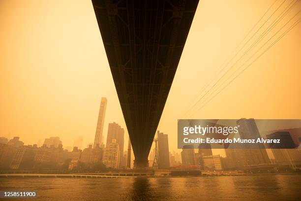 View of the Ed Koch Queensboro Bridge as smoke from Canadian wildfires casts a haze over the area on June 7, 2023 in New York City. Air pollution...