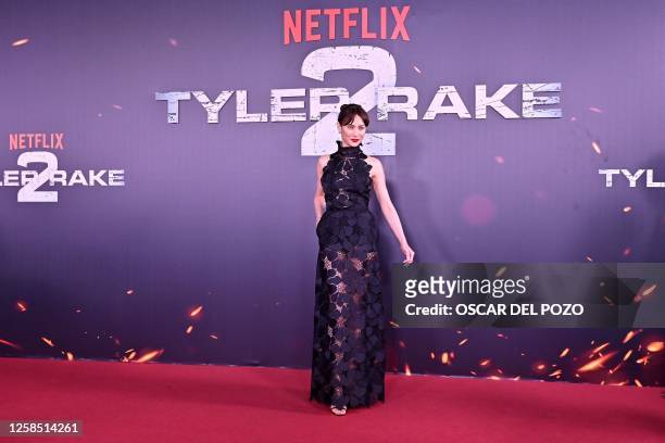 Ukrainian-French actress Olga Kurylenko poses for a photograph as she arrives to the premiere of Netflix US Serie 'Tyler Rake 2' in Madrid on June 7,...
