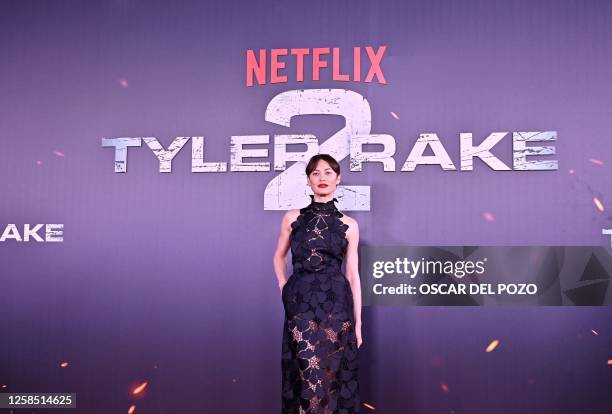 Ukrainian-French actress Olga Kurylenko poses for a photograph as she arrives to the premiere of Netflix US Serie 'Tyler Rake 2' in Madrid on June 7,...