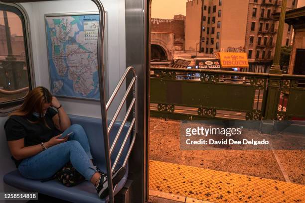 Person on the subway wears a fmask as smoky haze from wildfires in Canada blankets a neighborhood on June 7, 2023 in the Bronx borough of New York...