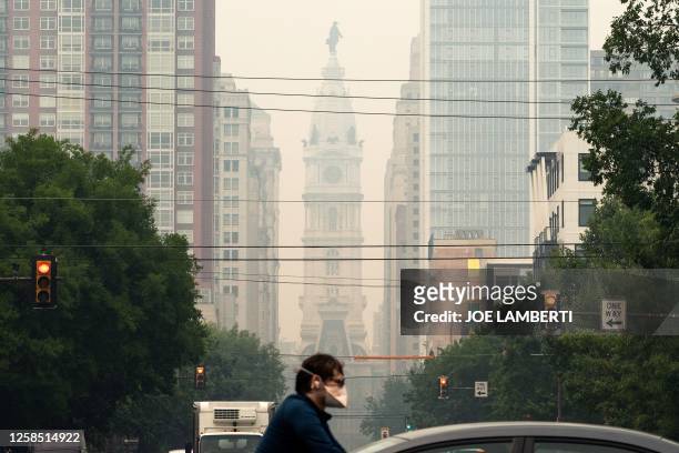 Haze covers Philadelphia City Hall, caused by smoke from Canada's wildfires on June 7, 2023. An orange-tinged smog caused by Canada's wildfires...