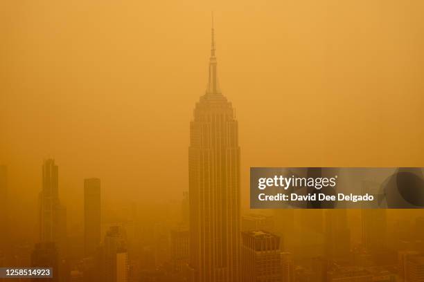Smoky haze from wildfires in Canada diminishes the visibility of the Empire State Building on June 7, 2023 in New York City. New York topped the list...