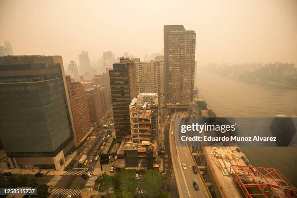 Traffic moves over the FDR drive as smoke from Canadian wildfires casts a haze over the area on June 7, 2023 in New York City. Air pollution alerts...