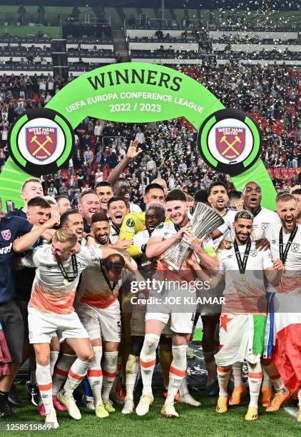 West Ham players including English midfielder Declan Rice celebrate with the trophy after winning the UEFA Europa Conference League final football...