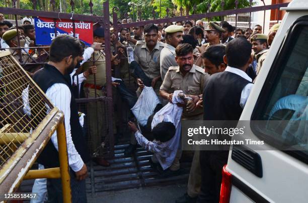 Police carrying the attacker caught at the court premises after gangster Sanjeev Jeeva was shot dead at old high court on June 7, 2023 in Lucknow,...