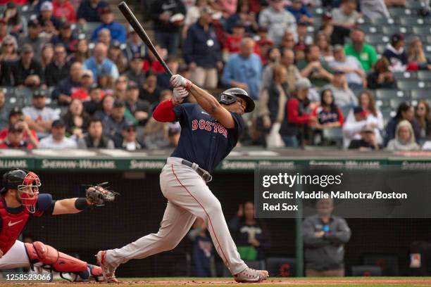 Rafael Devers of the Boston Red Sox hits an rbi single during the first inning of a game against the Cleveland Guardians on June 7, 2023 at...