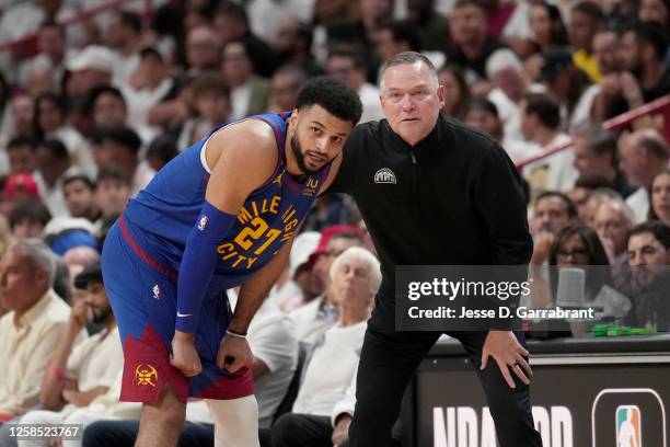 Jamal Murray of the Denver Nuggets talks with Head Coach Michael Malone of the Denver Nuggets during Game Three of the 2023 NBA Finals on June 7,...