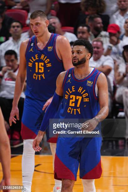 Nikola Jokic and Jamal Murray of the Denver Nuggets stand on the court during Game Three of the 2023 NBA Finals against the Miami Heat on June 7,...