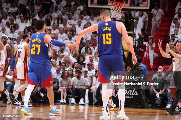 Jamal Murray and Nikola Jokic of the Denver Nuggets high five during Game Three of the 2023 NBA Finals against the Miami Heat on June 7, 2023 at...