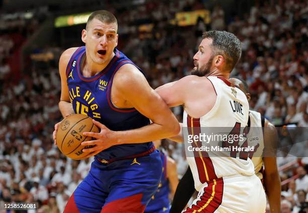 The Denver Nuggets&apos; Nikola Jokic drives against the Miami Heat&apos;s Kevin Love during the first half of Game 3 of the NBA Finals at the Kaseya...
