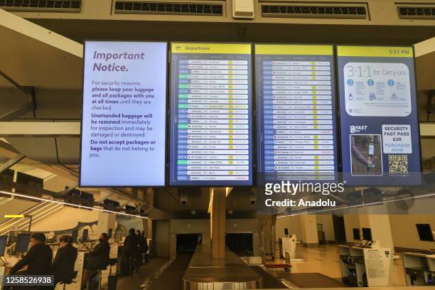 Flight information display board is seen after the US Federal Aviation Administration warned travelers to expect flights to be delayed at LaGuardia...