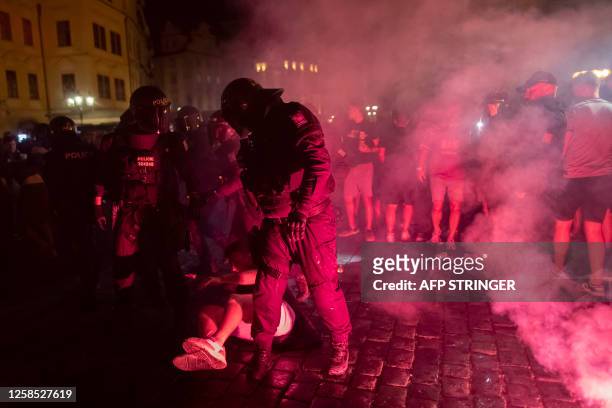 Czech riot police controls a crowd of West Ham United supporters celebrating at the Old Town Square after their team won the UEFA Europa Conference...