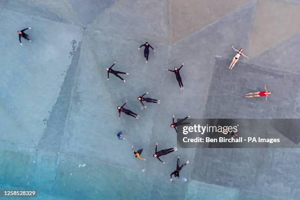 People float above patterns seen on the concrete base of the pool at The Wave, which is England's only inland surfing destination, located near...