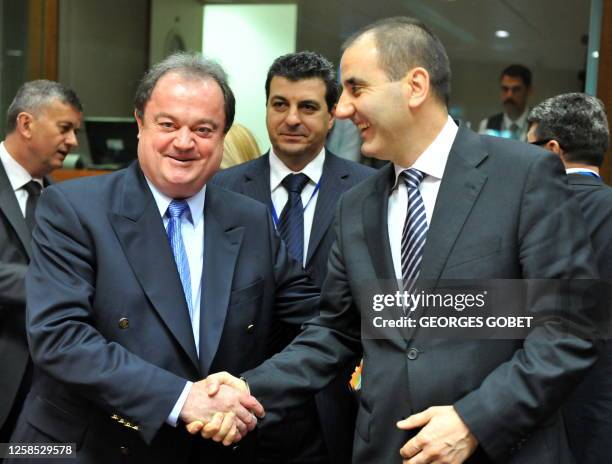 Romanian Minister of Administration and Interior Vasile Blaga shakes hand with Bulgarian Interior Minister Tsvetan Tsvetanov prior to the Justice and...