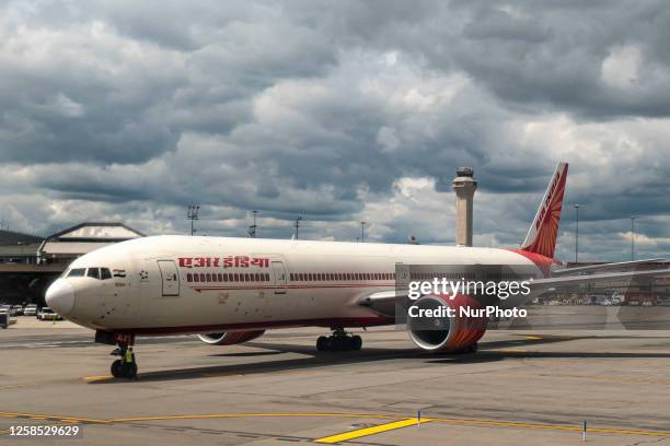Air India Boeing 777 passenger aircraft as seen on the tarmac of Newark Liberty International Airport in the United States with the control tower and...