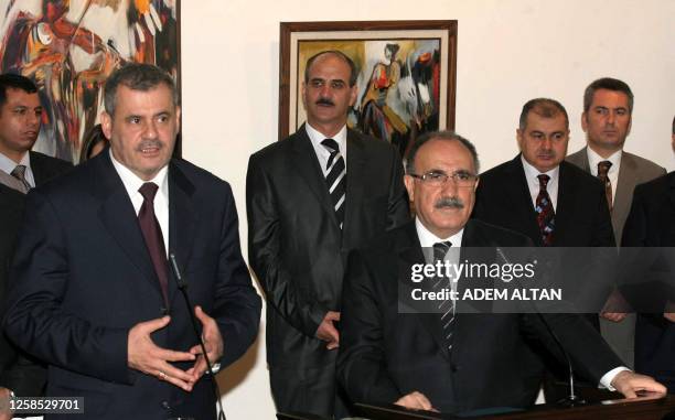 Turkish Interior Minister Besir Atalay, right, and Iraqi Minister of State for National Security Shirwan al-Waili, left, speak to the media at a news...