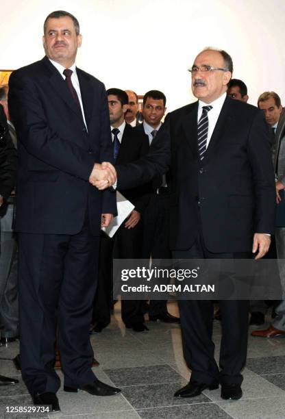 Turkish Interior Minister Besir Atalay, right, and Iraqi Minister of State for National Security Shirwan al-Waili, left, pose at a news conference...