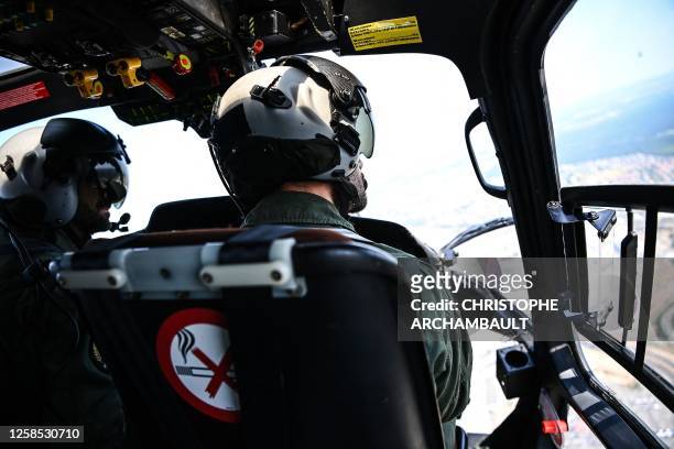 Pilot of a French army Fennec helicopter performs a reconnaissance flight ahead of the July 14 air parade above Paris and its western suburbs on June...