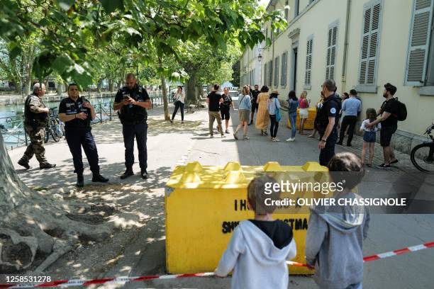 French police personnel maintain a secure cordon in Annecy, south-eastern France on June 8 following a mass stabbing in the French Alpine town. Seven...