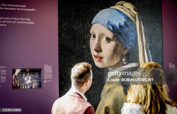 Visitors look at a 4-meter-high 3D print of Johannes Vermeer's painting "Girl with a Pearl Earring", displayed at The Mauritshuis Museum in The Hague...