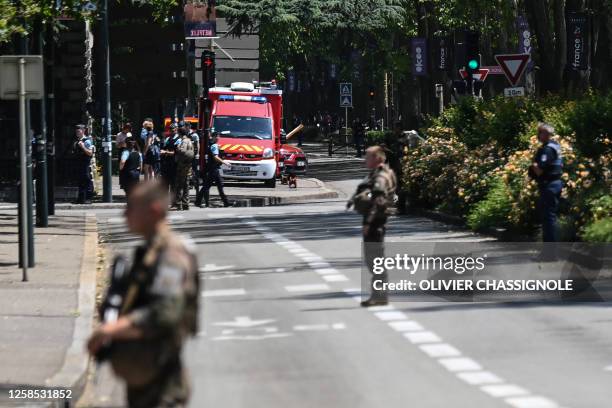 French police officers stand next to an emergency truck in Annecy, central-eastern France on June 8 following a mass stabbing in the French Alpine...