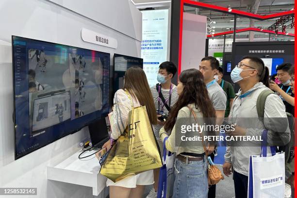 Staff members of SenseTime show how their products can be used to defer certain undesirable behaviours during the Security China 2023 China...