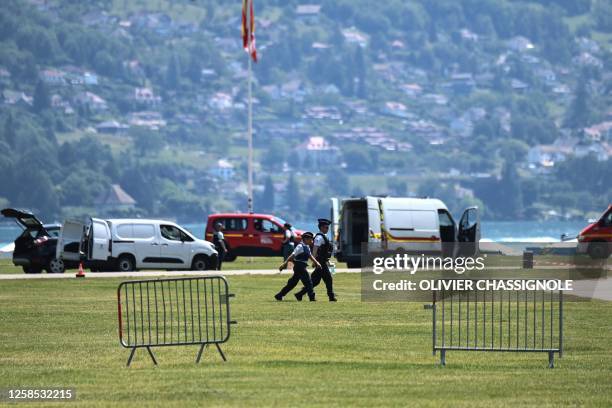 French police officers walk in the 'Jardins de l'Europe' in Annecy, central-eastern France on June 8 following a mass stabbing in the French Alpine...