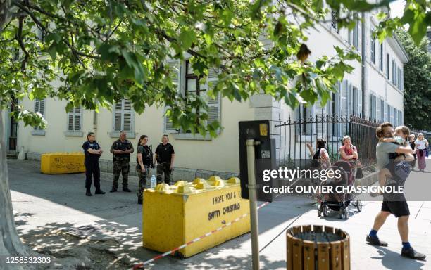 French police personnel maintain a secure cordon in Annecy, south-eastern France on June 8 following a mass stabbing in the French Alpine town. Seven...