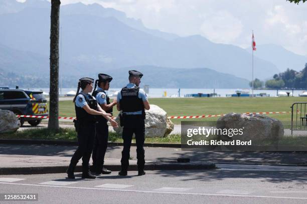 Law enforcement stand near a park where a man stabbed multiple people on June 8, 2023 in Annecy, France. Four children were among the victims in a...