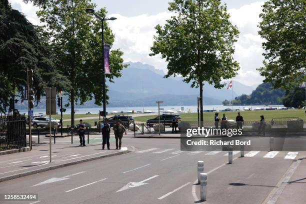 Law enforcement stand near a park where a man stabbed multiple people on June 8, 2023 in Annecy, France. Four children were among the victims in a...