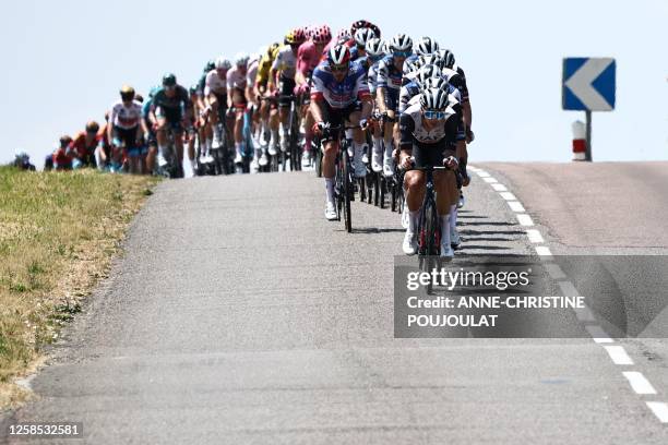 The pack rides during the fifth stage of the 75th edition of the Criterium du Dauphine cycling race 5km between Cormoranche-sur-Saone and...