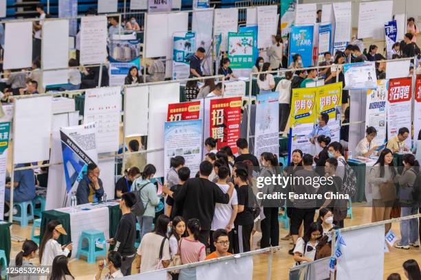 Students look for employment opportunities at a job fair in Zhengzhou University in Zhengzhou in central China's Henan province Wednesday, June 07,...