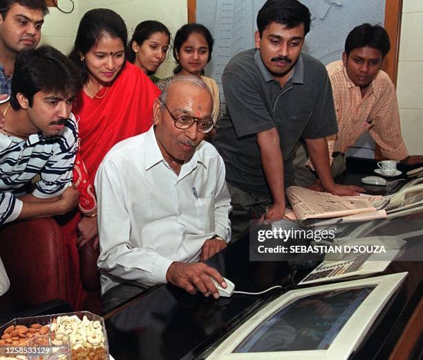 Staff of Damani Securities watch their boss in a mock trading session, 01 January 2000 in Bombay, where the Bombay Stock Exchange had a three hour...