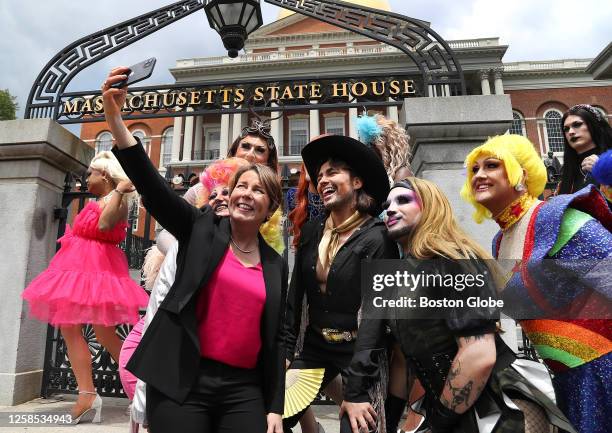 Massachusetts Governor Maura Healey takes a selfie on the State House steps as drag queens joined politicians and LGBTQ+ Legislative Caucus and...