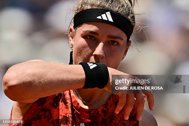 Czech Republic's Karolina Muchova wipes her face with her wristband as she plays against Belarus' Aryna Sabalenka during their women's singles...