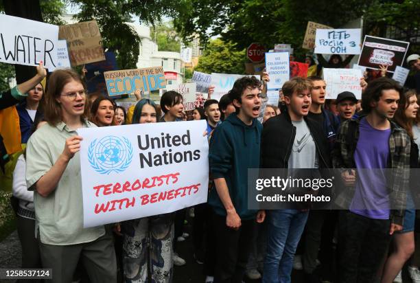 Ukrainian students shout slogans as they take part at a rally demanding recognize the blowing of the dam at the Kakhovka Hydroelectric Power Plant as...