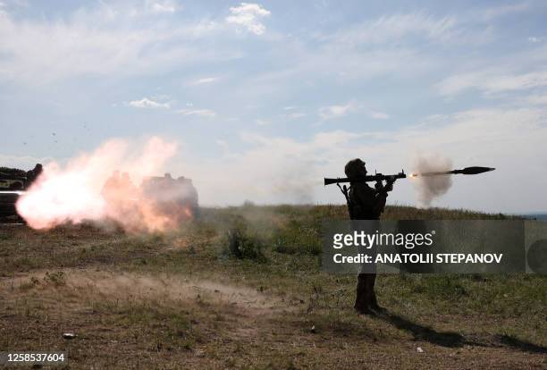 Ukrainian serviceman fires a rocket launcher during a military training exercise not far from front line in Donetsk region on June 8, 2023.