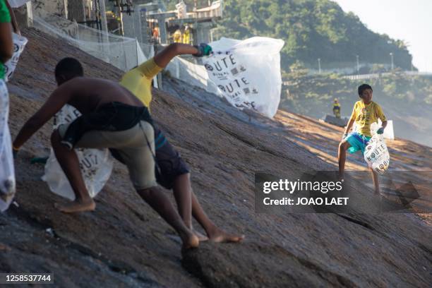 Volunteers from a Non-Governmental Organization clean the Sao Conrado beach in Rio de Janeiro, Brazil on June 8, 2023 in the framework of the World...