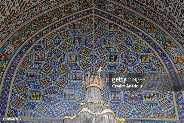 Bird is seen on the chandelier of the Goharshad Mosque at the province of Razavi Khorasan in Mashhad, Iran on May 29, 2023. The mosque was built...